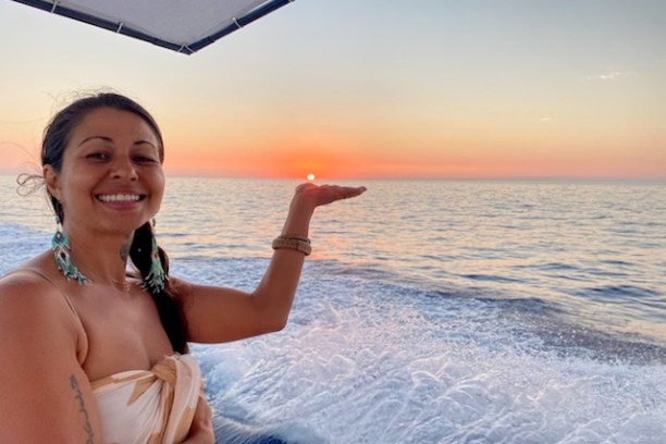 a woman standing next to a body of water