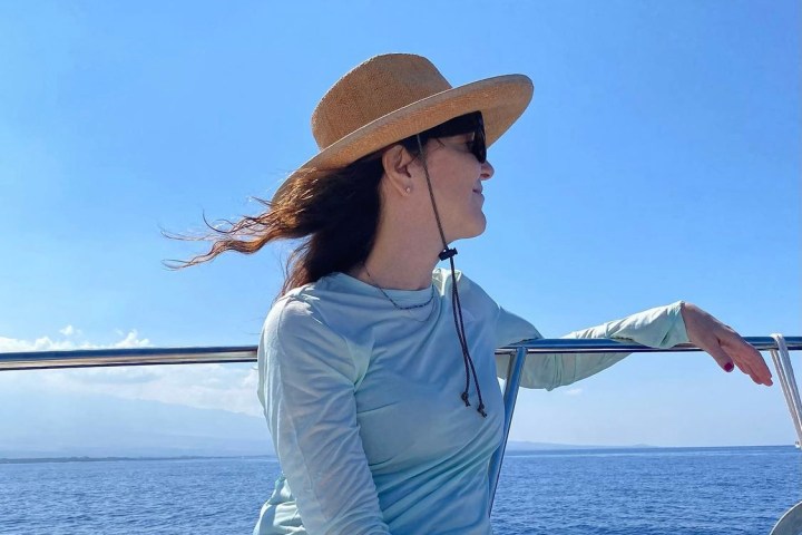 a person standing next to a body of water