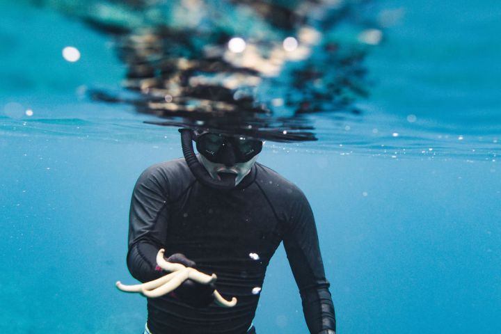 a person standing next to a body of water