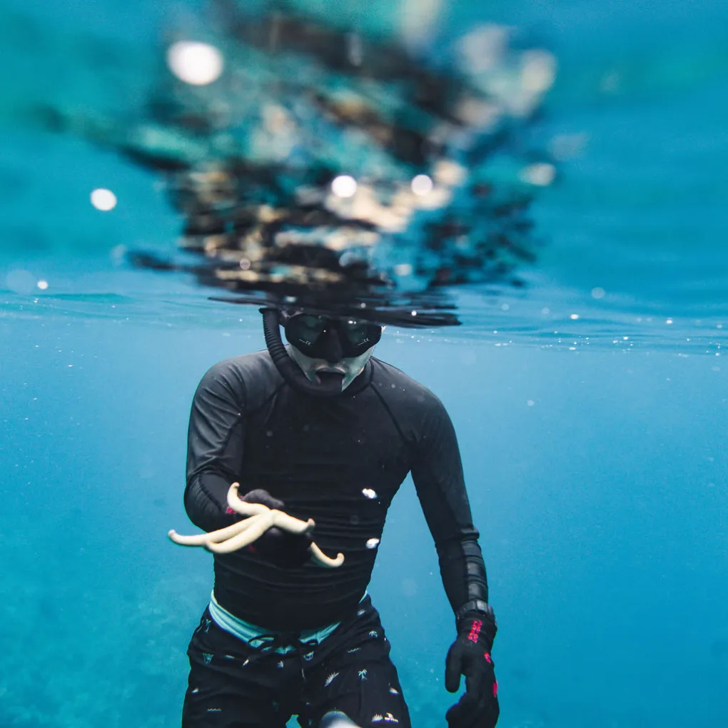 a person standing next to a body of water