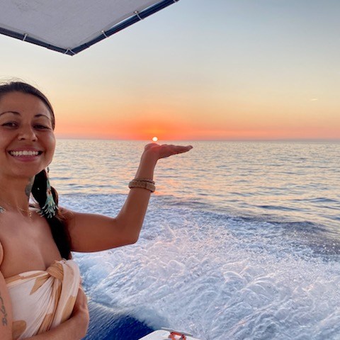 a woman standing next to a body of water