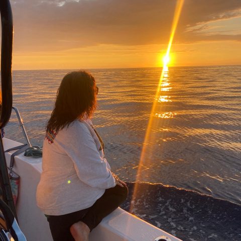 a person standing next to a body of water